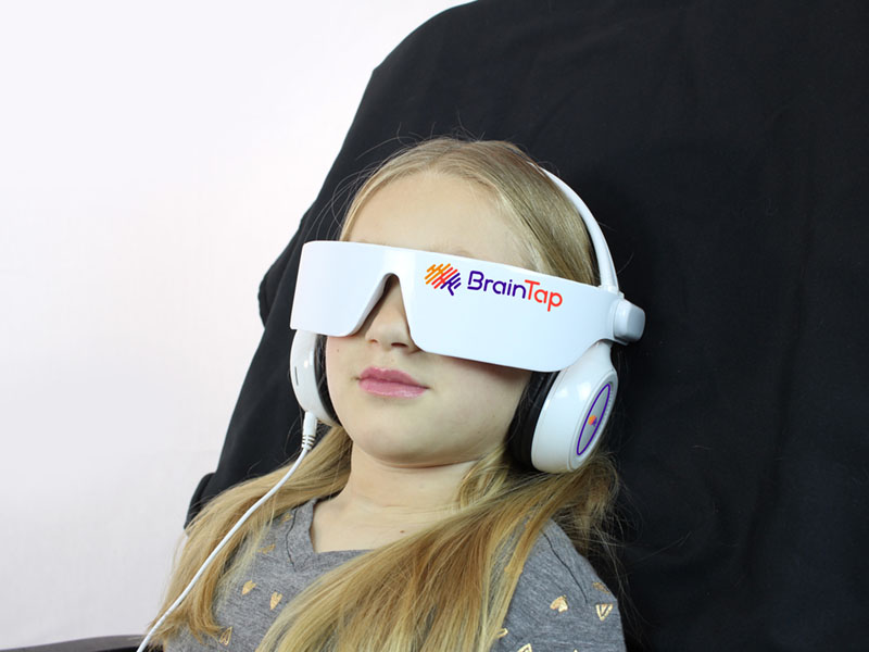 Child experiencing a Braintap session to help with ADHD, learning performance and anxiety