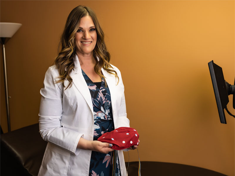 Chiropractic neurologist setting up a Braincore neurofeedback session in a Smithton clinic New Beginning Wellness Center