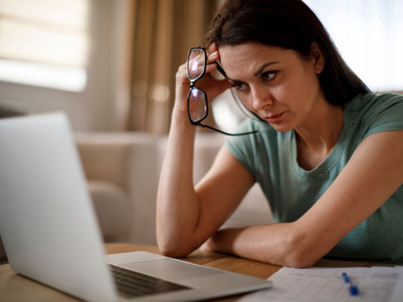 Woman struggling to get concentrated working behind the computer because of her ADHD symptoms