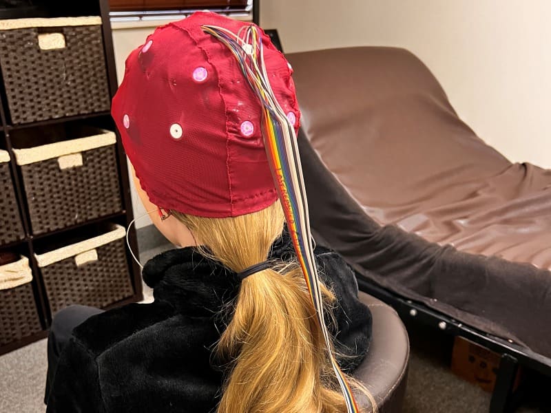 Young girls sitting in a chair at new beginning Wellness Center during a qEEG brainmap test for ADHD 