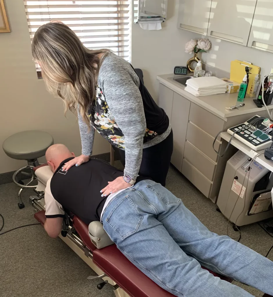 chiropractor-near-me-smithtown Dr Keri Chiappino performing a chiropractic adjustment in her Smithtown chiropractic office
